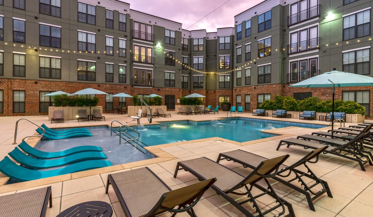 Resort-style pool and patio with lounge chairs at 1400 Chestnut Apartments, Chattanooga, Tennessee