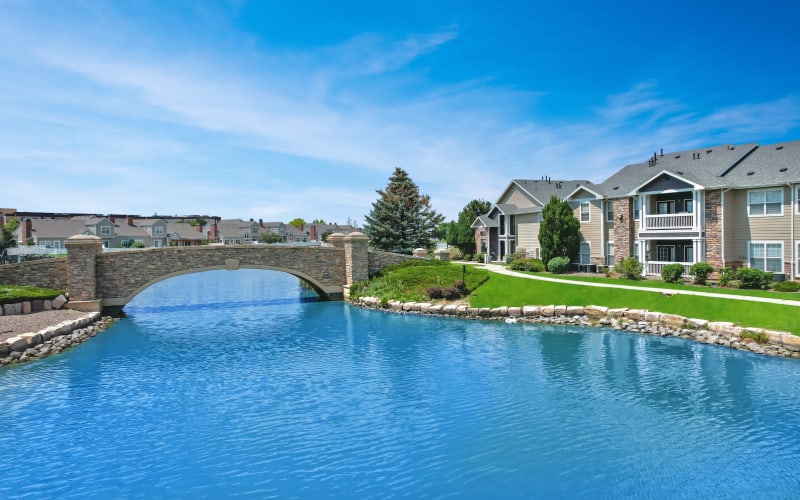 Exterior View of Lake, Bridge, and Surrounding Property Buildings of Gateway Park Apartments in Denver, Colorado