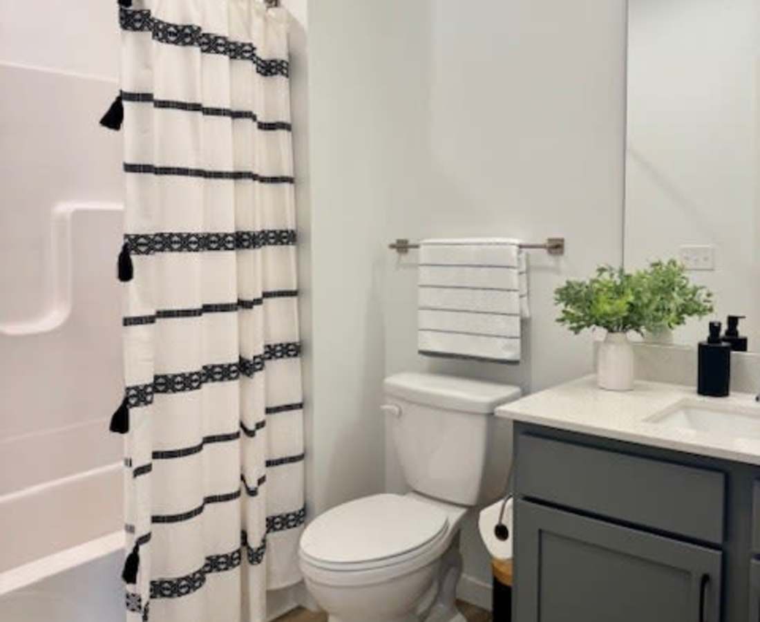 White shower curtain with black accents at Pritchard Park Place in Racine, Wisconsin