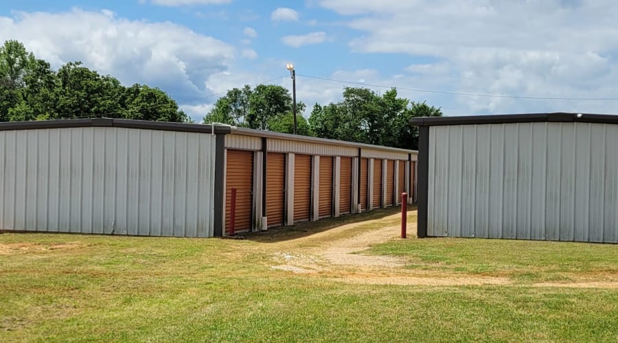 A family carrying storage boxes into their new home near KO Storage in Gilmer, Texas