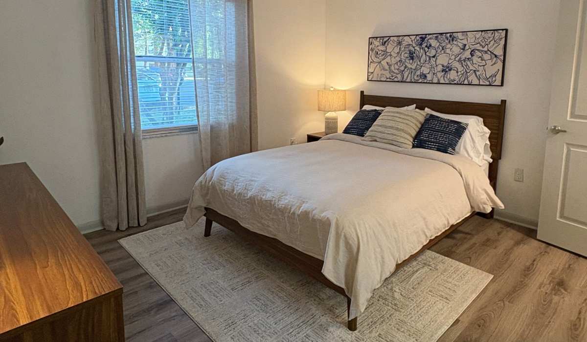 Spacious bedroom with large window at Hunters Run in Gainesville, Florida