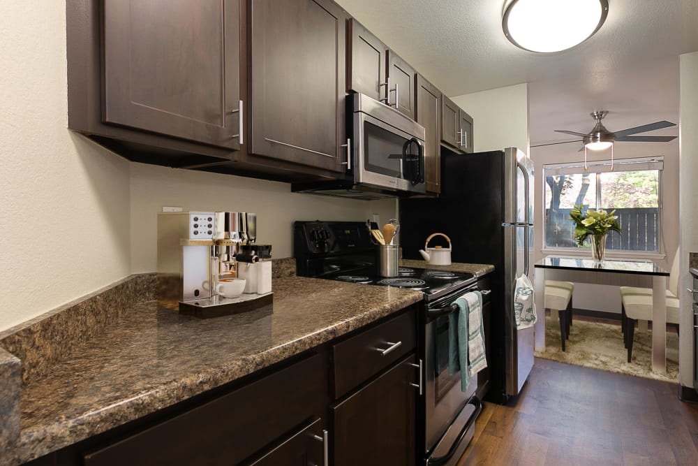 Kitchen with wood-style flooring at Latitude Apartments in Everett, Washington