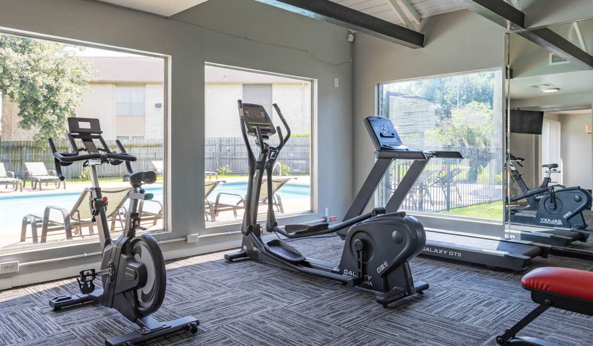 Fitness center with cardio equipment at University Green Apartments in Houston, Texas
