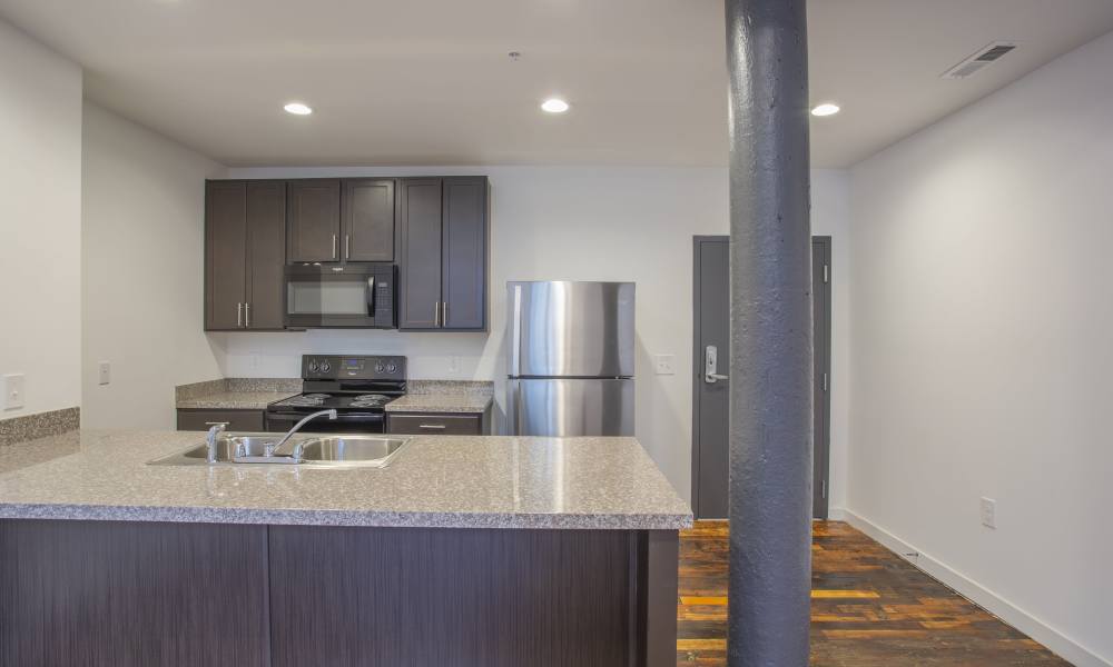 Well-equipped kitchen at Lofts at Inman Mills in Inman, South Carolina