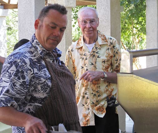 Staff and resident BBQing at Arbors Memory Care in Sparks, NV