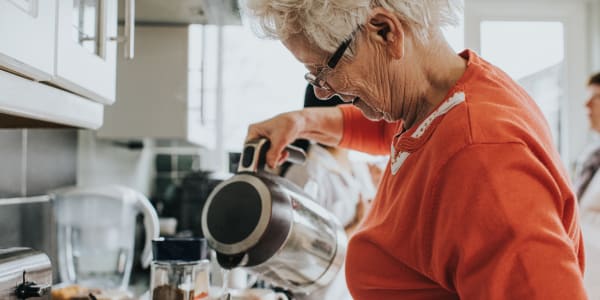 Resident preparing herself a cup of tea at Fair Oaks Health Care Center in Crystal Lake, Illinois