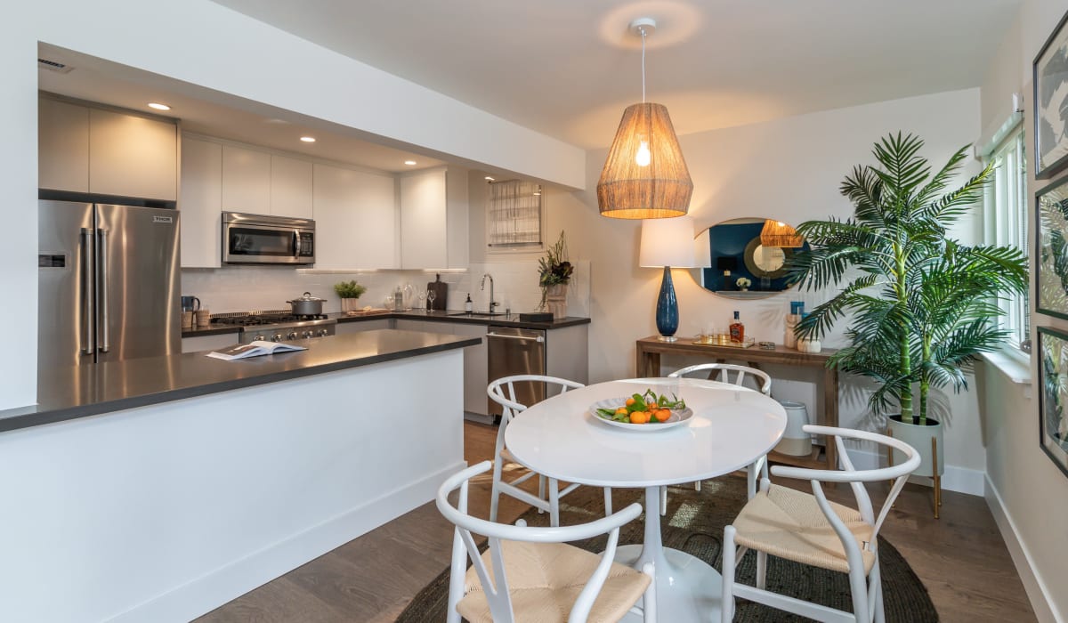 Stainless steel appliances in an open kitchen next to the dining room in an apartment at Sharon Green in Menlo Park, California