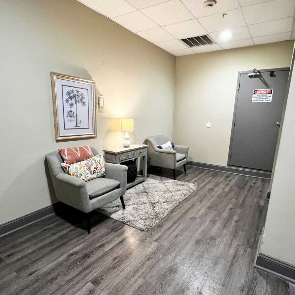 Sitting area with sofa and rug at Main Street Living in Columbia, South Carolina