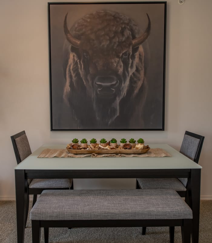 Dining table below buffalo art at Ridge at 66 in Yukon, Oklahoma