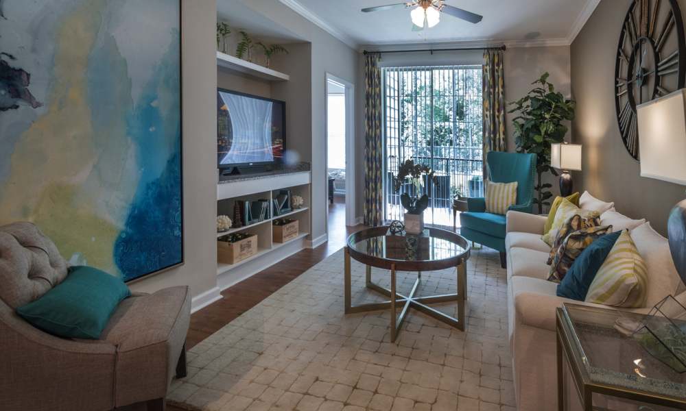 Living room having a couch, coffee table and a glass door at Avonlea On The River in Duluth, Georgia