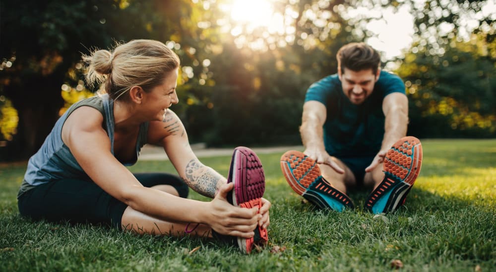 Residents stretch after running in park near Beacon on 5th in Charlottesville, Virginia