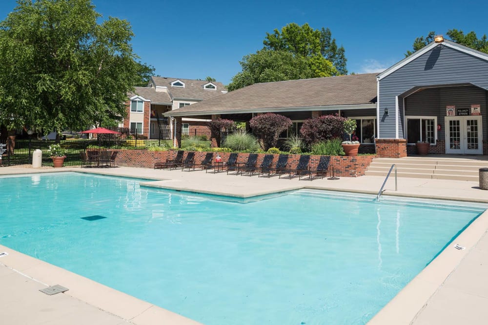 A swimming pool with a large sundeck at Sunbrook Apartments in Saint Charles, Missouri