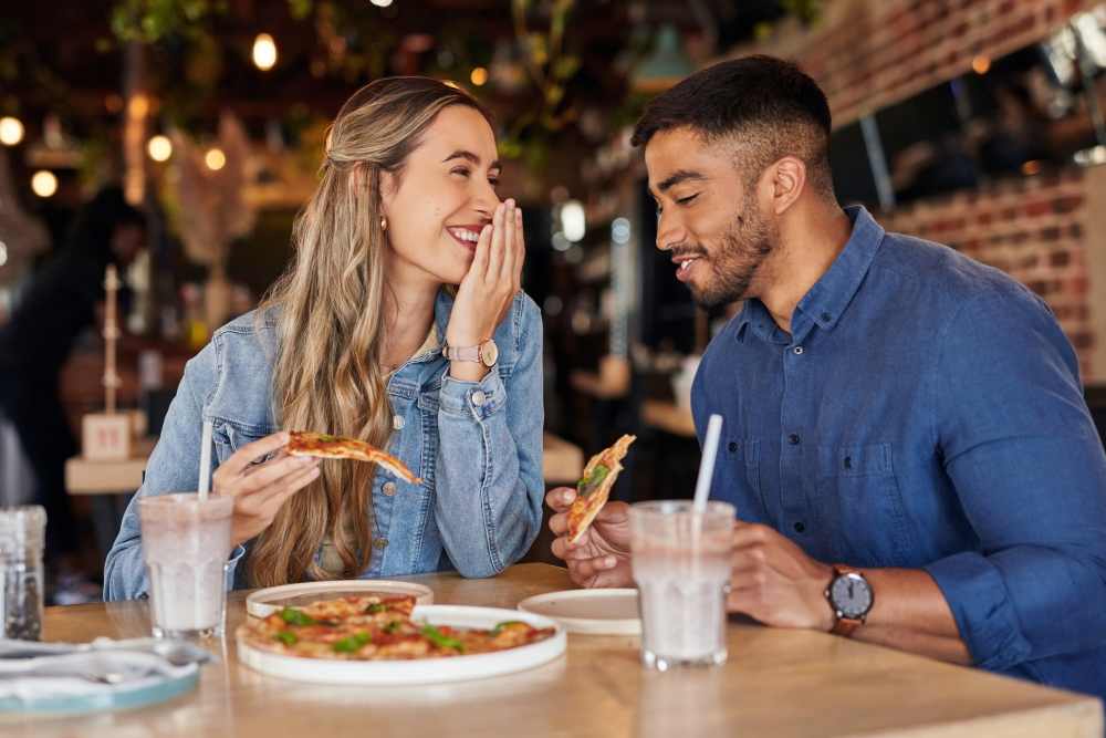 Couple enjoying pizza at a local restaurant near Springfield Apartments in Murfreesboro, Tennessee