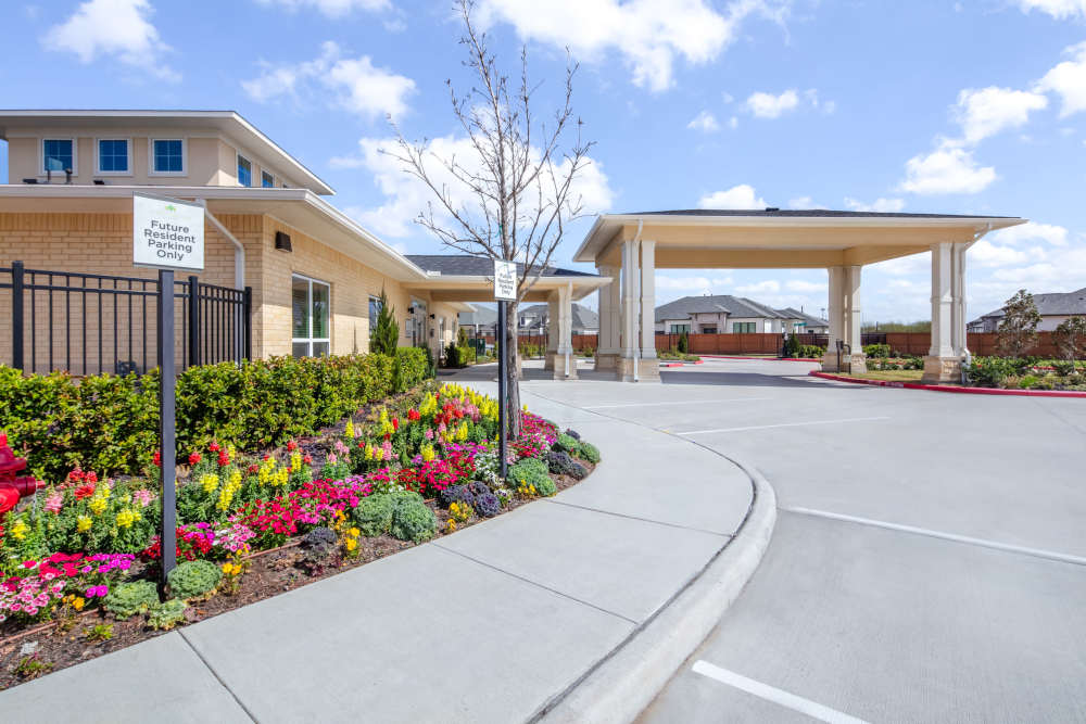 Welcoming entrance with beautiful flower beds at Springwood at Aliana in Richmond, Texas