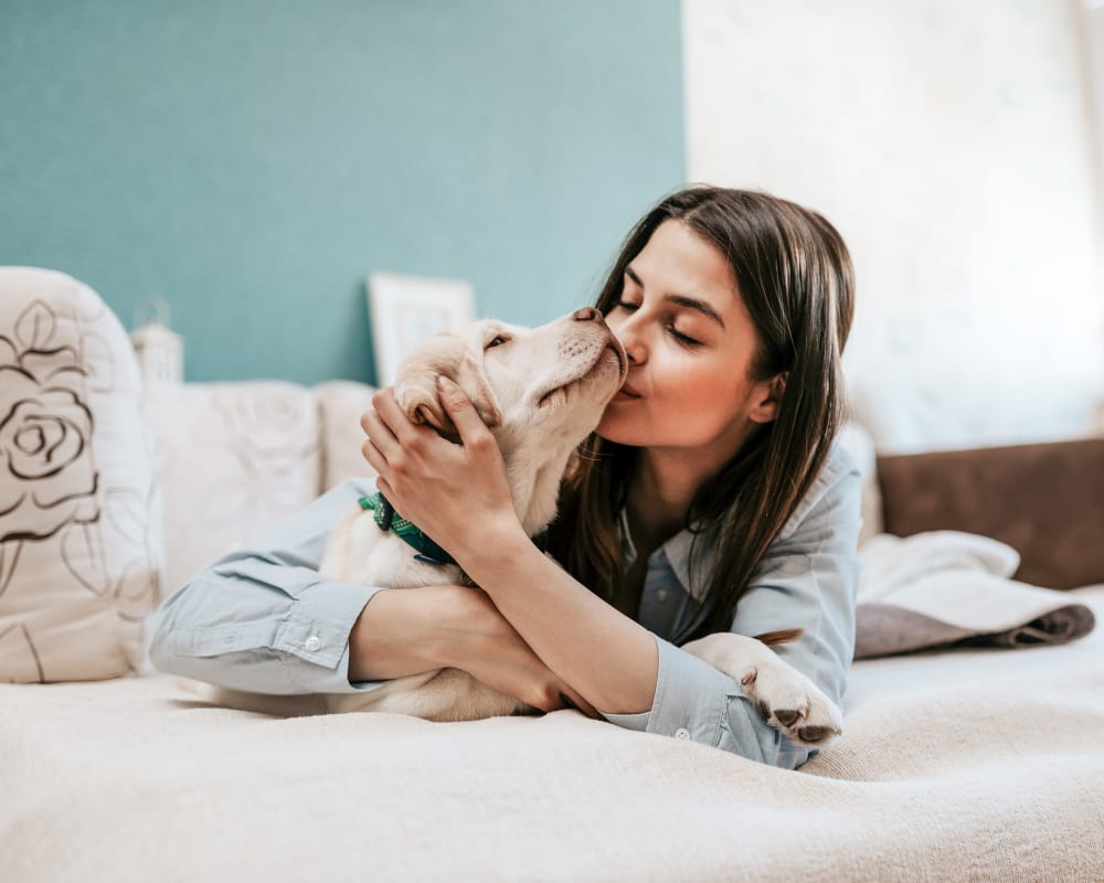 Resident giving her dog a kiss at Acqua Apartments in Portland, Oregon