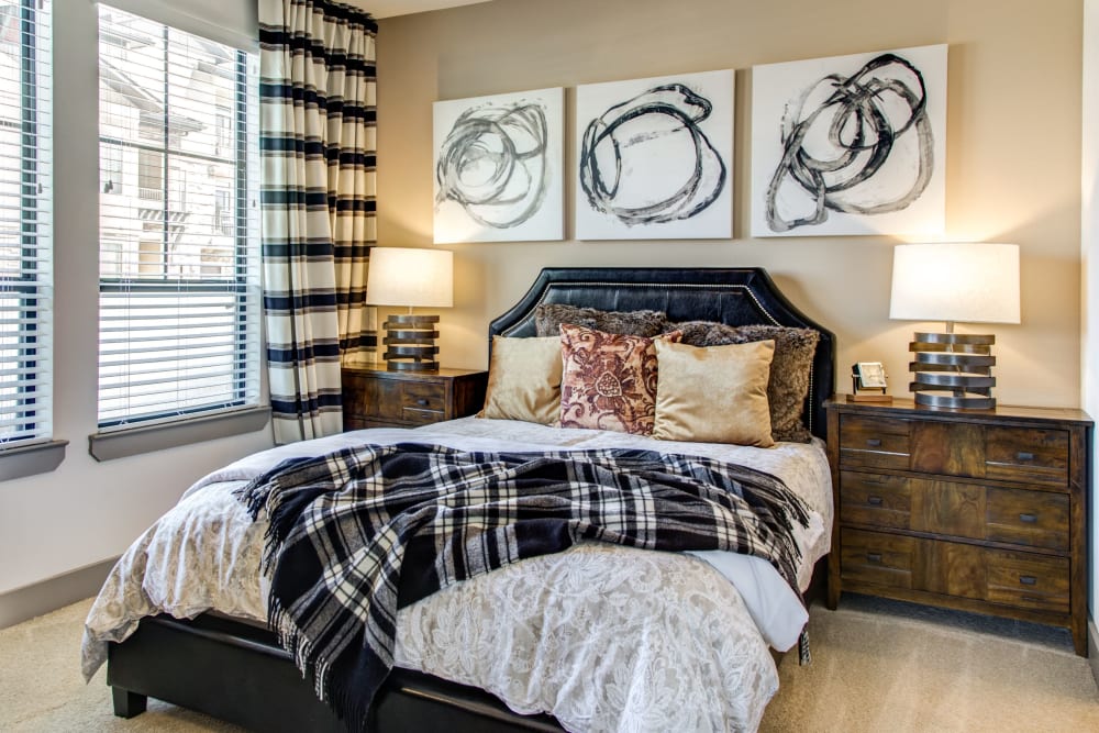 Modern furnishings in the bedroom of a model home at Waterford Trails in Spring, Texas