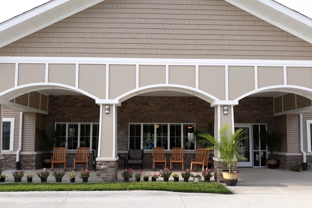 Outdoor covered sitting area with rocking chairs at Country Meadow Place in Mason City, Iowa