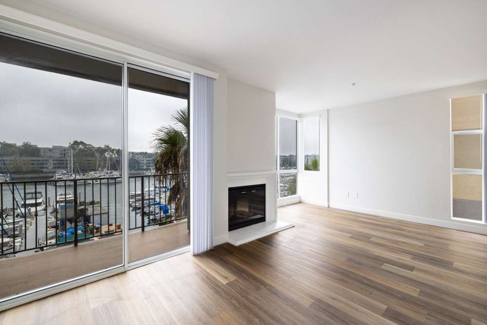 Luxury wooden flooring and fireplace with view at Capri Apartments in Marina Del Rey, California