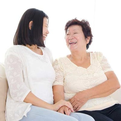 Mother and daughter talking and laughing together at Arcadia Senior Living Pace in Pace, Florida