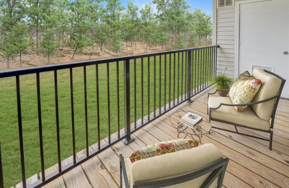 Staged balcony overlooking grass and a treeline at Brookside Manor Apartments & Townhomes in Lansdale, Pennsylvania