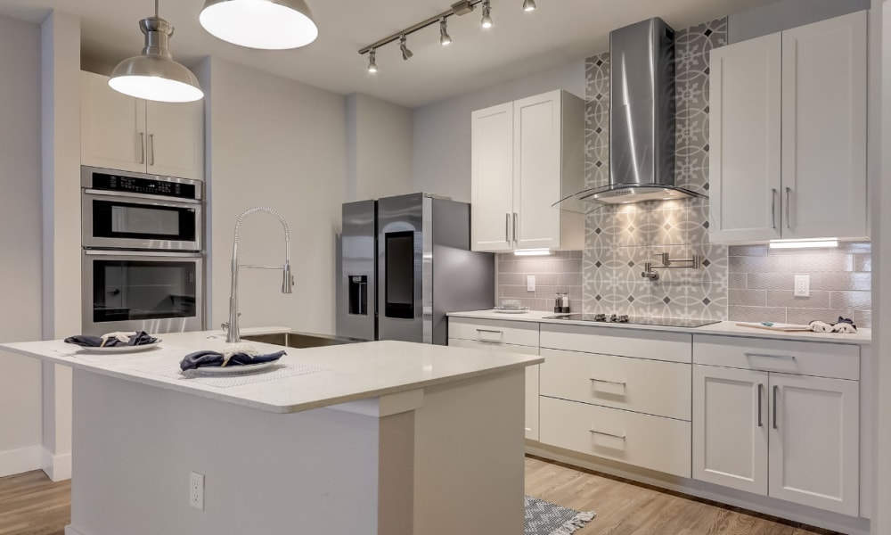 A modern apartment kitchen with an island at The Vivien in Vero Beach, Florida