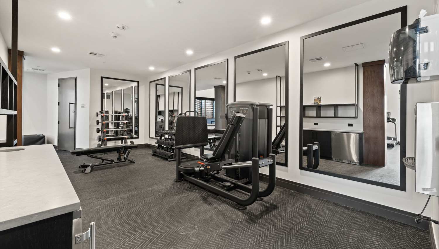 A well-equipped gym room with a range of exercise equipment at The Lock at Flatirons, Broomfield, Colorado