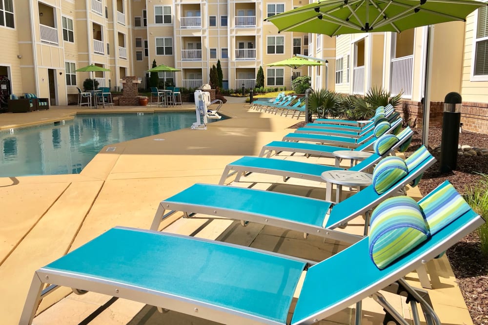 Poolside lounge chairs outside at Level at 401 in Raleigh, North Carolina
