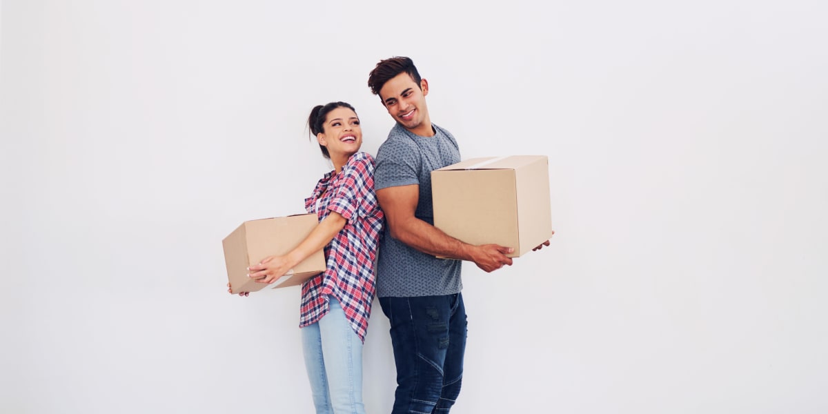 A couple carrying boxes into storage at Stor-Room Mini Storage in Troutdale, Oregon