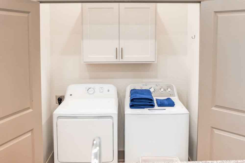 Washer and dryer of an apartment at The Waters at Promenade in Marrero, Louisiana