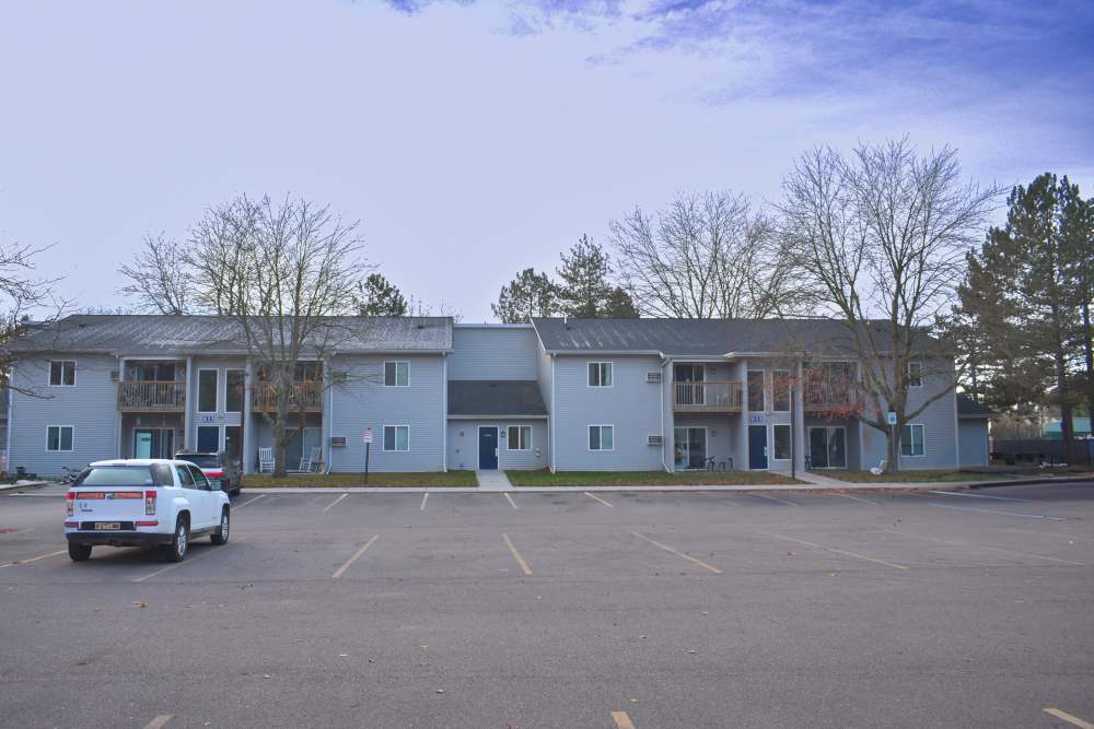Community exterior with car parking at Lakewood Apartments in Stockbridge, Michigan
