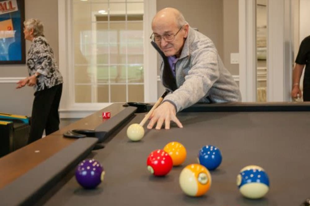 A resident playing a game of pool at Mercer Hill at Doylestown in Doylestown, Pennsylvania