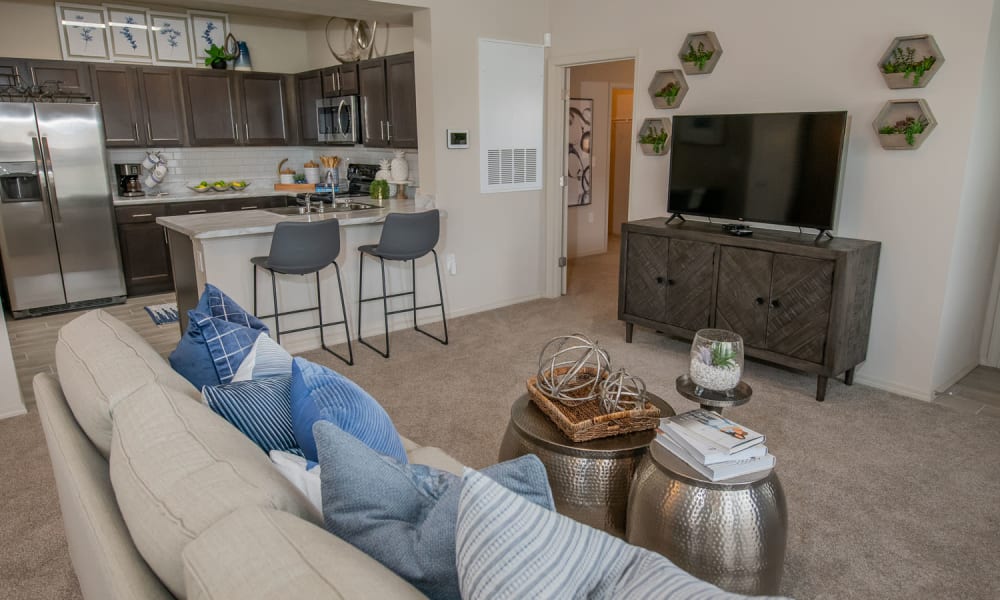 Model living room and kitchen at Redbud Ranch Apartments in Broken Arrow, Oklahoma