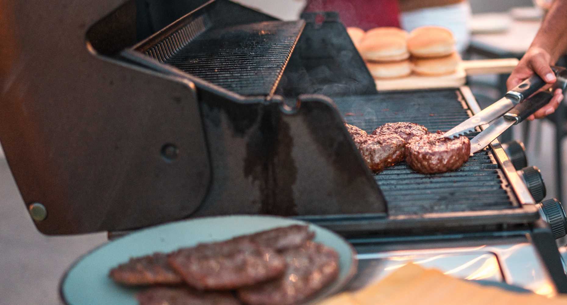 Residents grilling burgers at Flatiron District at Austin Ranch in The Colony, Texas