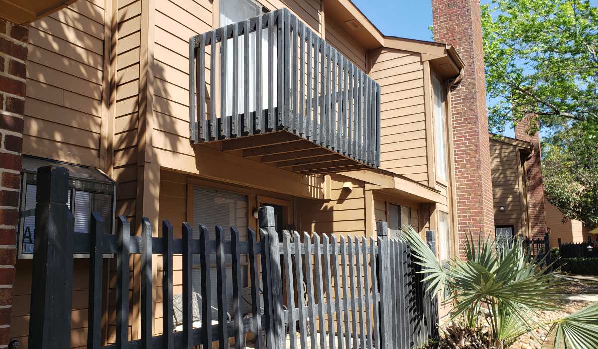 Apartment patio and balcony at Oaks of Kingwood Apartments in Kingwood, Texas