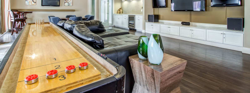 Resident clubhouse with a shuffleboard table at Abaco Key in Orlando, Florida