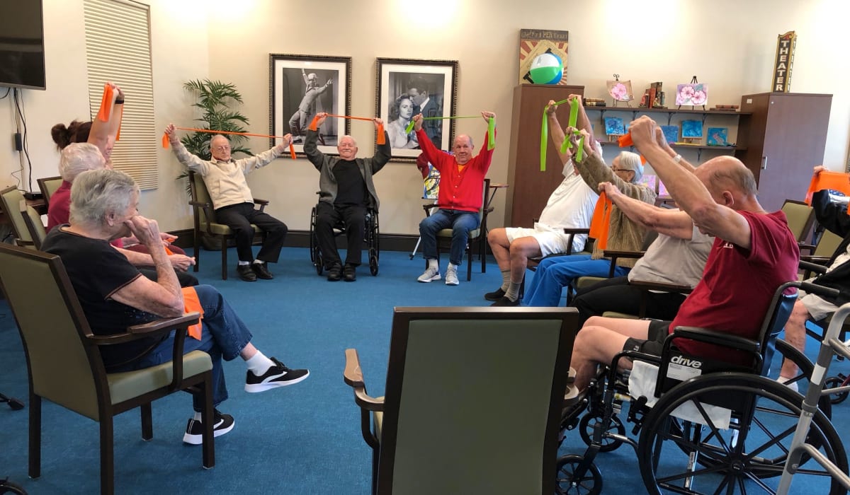 Residents stretching at CERTUS Premier Memory Care Living in Orange City, Florida.