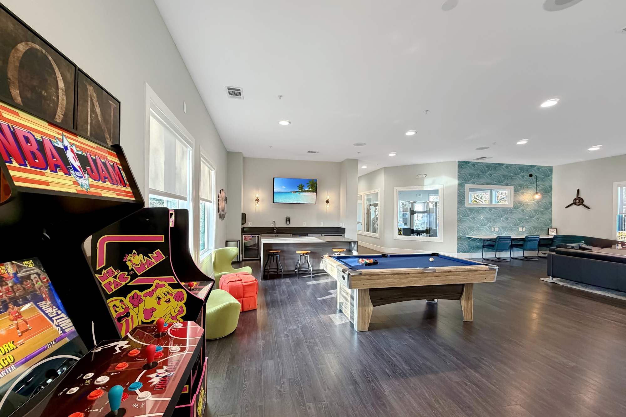 Lounge with billiards table and arcade games at Avion Apartments in Rancho Cordova, California