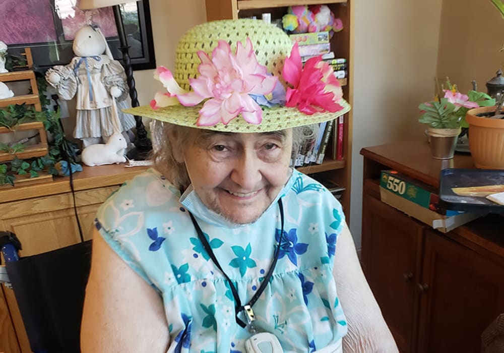 Happy resident with her flower hat at The Residences on Forest Lane in Montello, Wisconsin