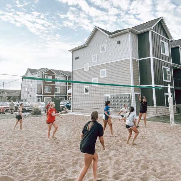 Residents playing volleyball at The Quarters at Vermillion in Vermillion, South Dakota