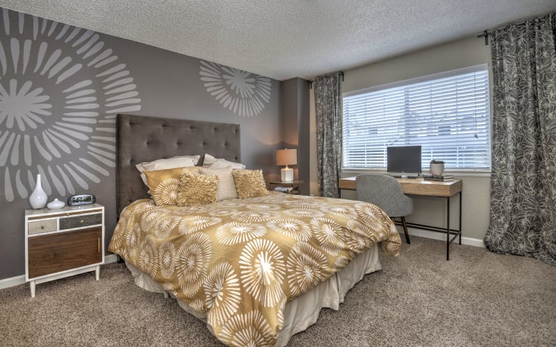 Spacious master bedroom with plush carpeting at Arapahoe Club Apartments in Denver, Colorado