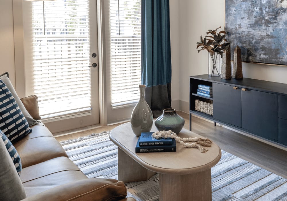 Living room with doors to balcony at The Everly at Rouzan in Baton Rouge, Louisiana