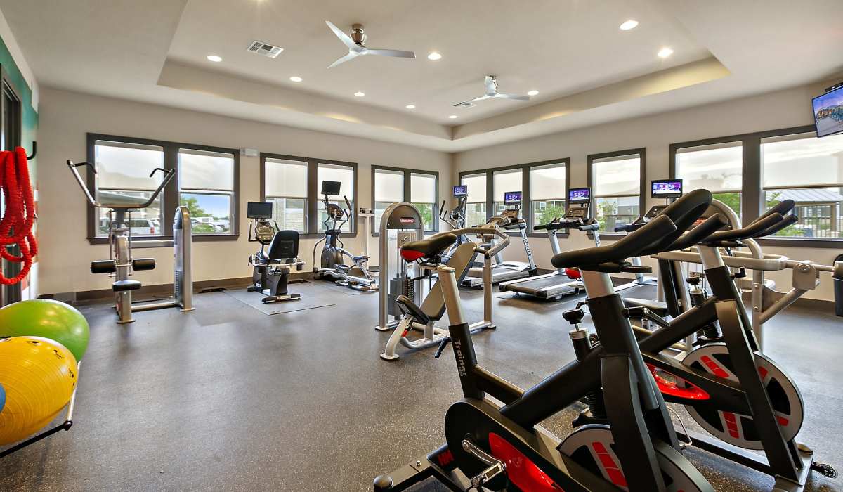 State-of-the-art fitness center with various equipment at Canyon House in New Braunfels, Texas