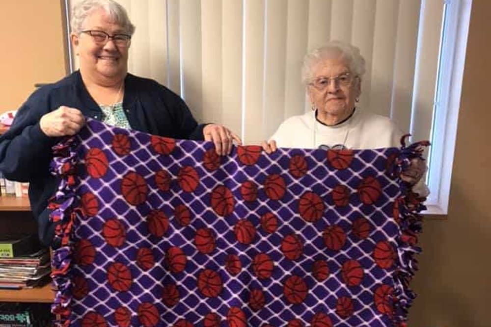 Residents display a blanket they made at Lawton Senior Living in Lawton, Iowa.