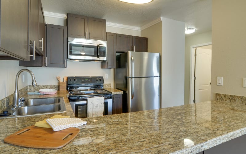 Renovated kitchen with stainless-steel appliances at Carriage House Apartments in Vancouver, Washington