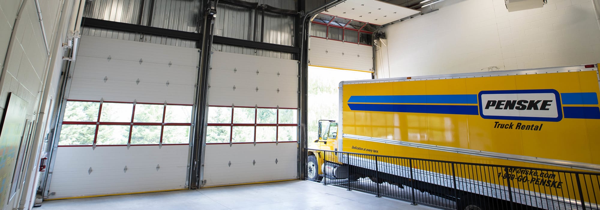 Large loading bay with a rental truck inside at Apple Self Storage - Kitchener - Highland in Kitchener, Ontario