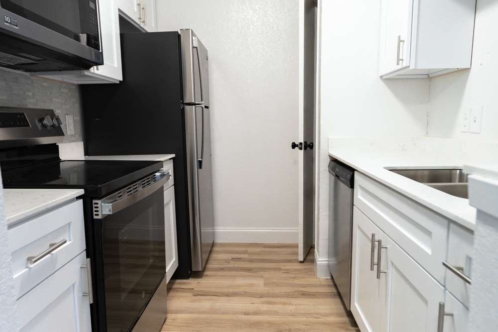 Kitchen withh white cabinetry at Lakeshore Villa Apartments in Rowlett, Texas