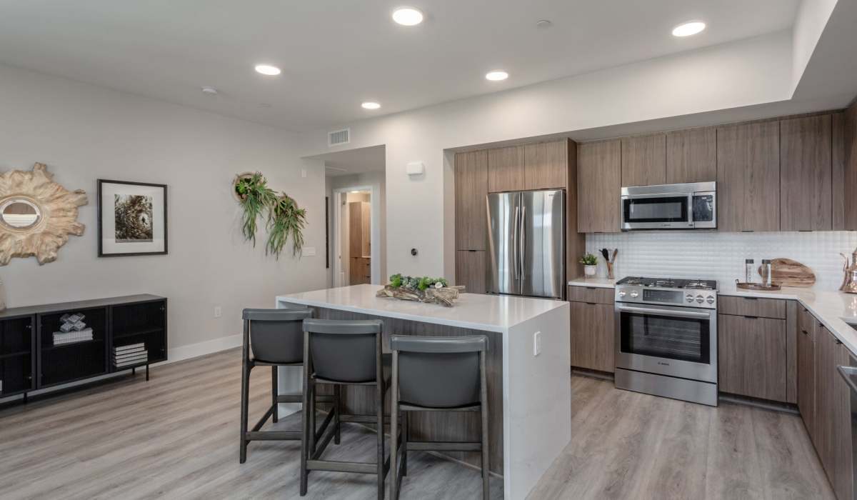 Spacious kitchen with stainless-steel appliances and wood-style flooring at Prado West in Dana Point, California