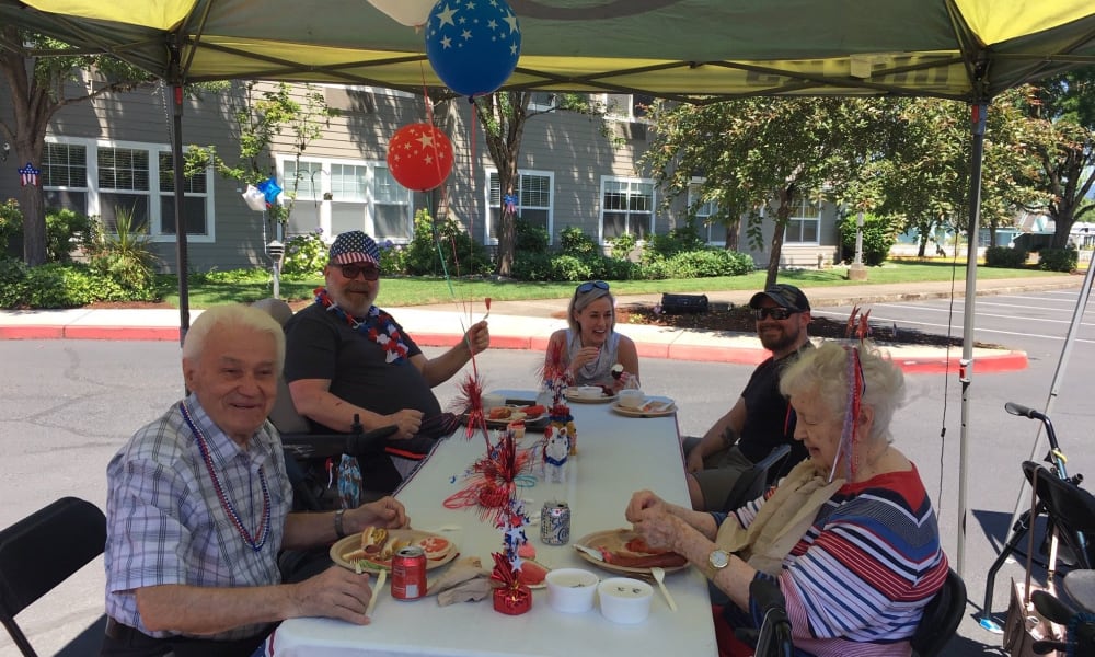 Residents enjoying a party outside at Woodside Senior Living in Springfield, Oregon