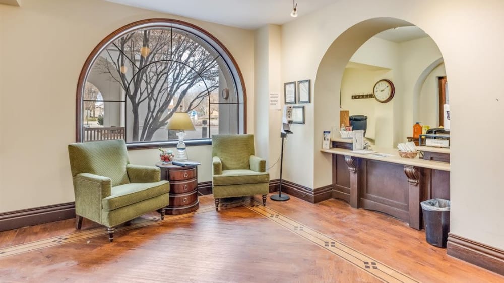 Lounge with armchairs and large window at Oxford Vista Wichita in Wichita, Kansas