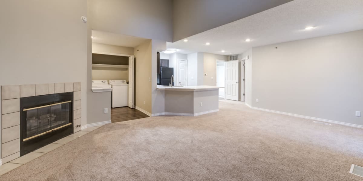 Carpeted living area with skylight and laundry closet at Ashford Belmar in Lakewood, Colorado